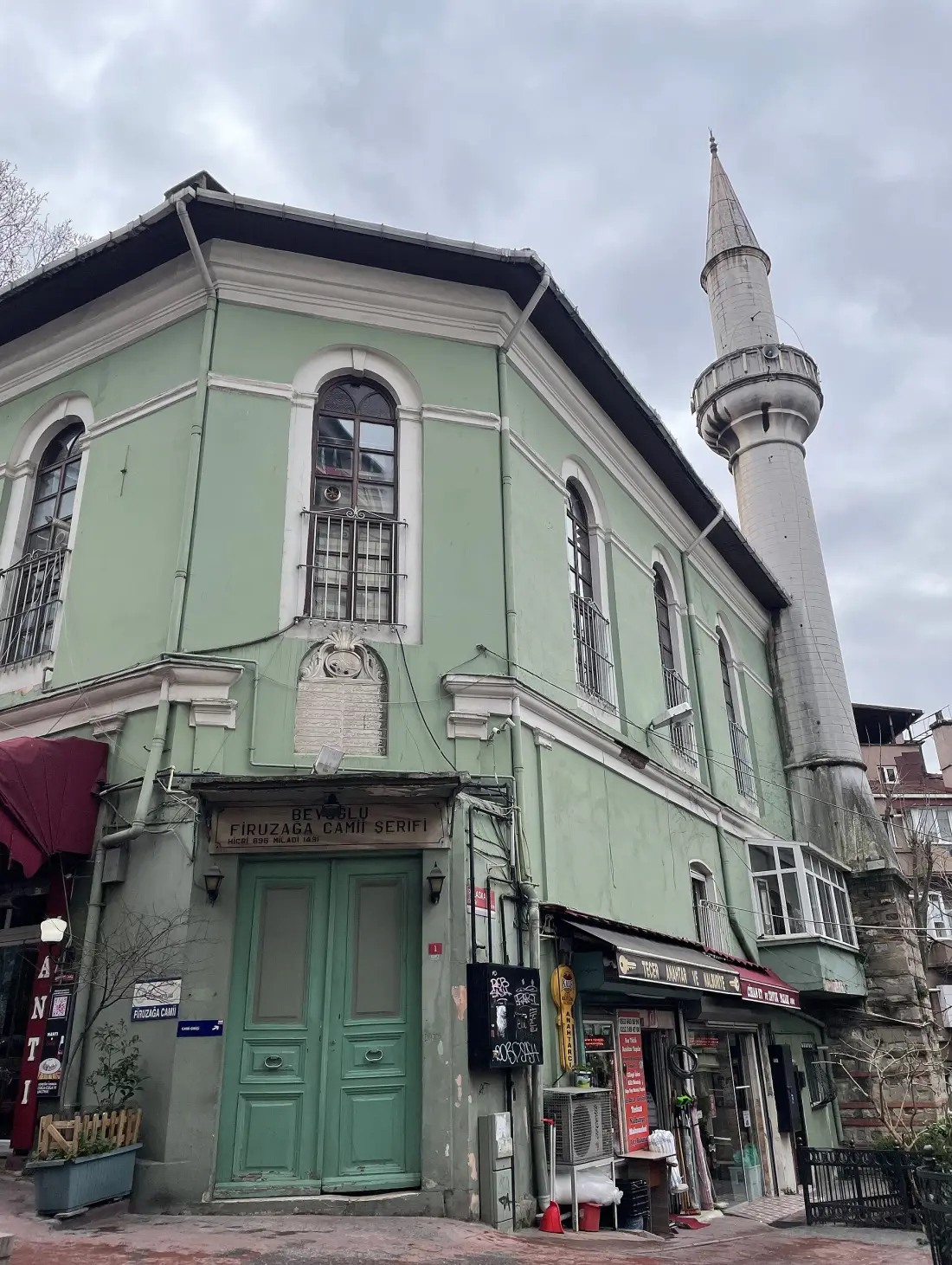 The green façade and minaret of Firuzağa Mosque