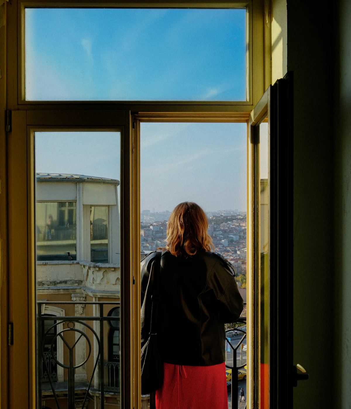 A woman looking out over Istanbul from a balcony in Beyoğlu