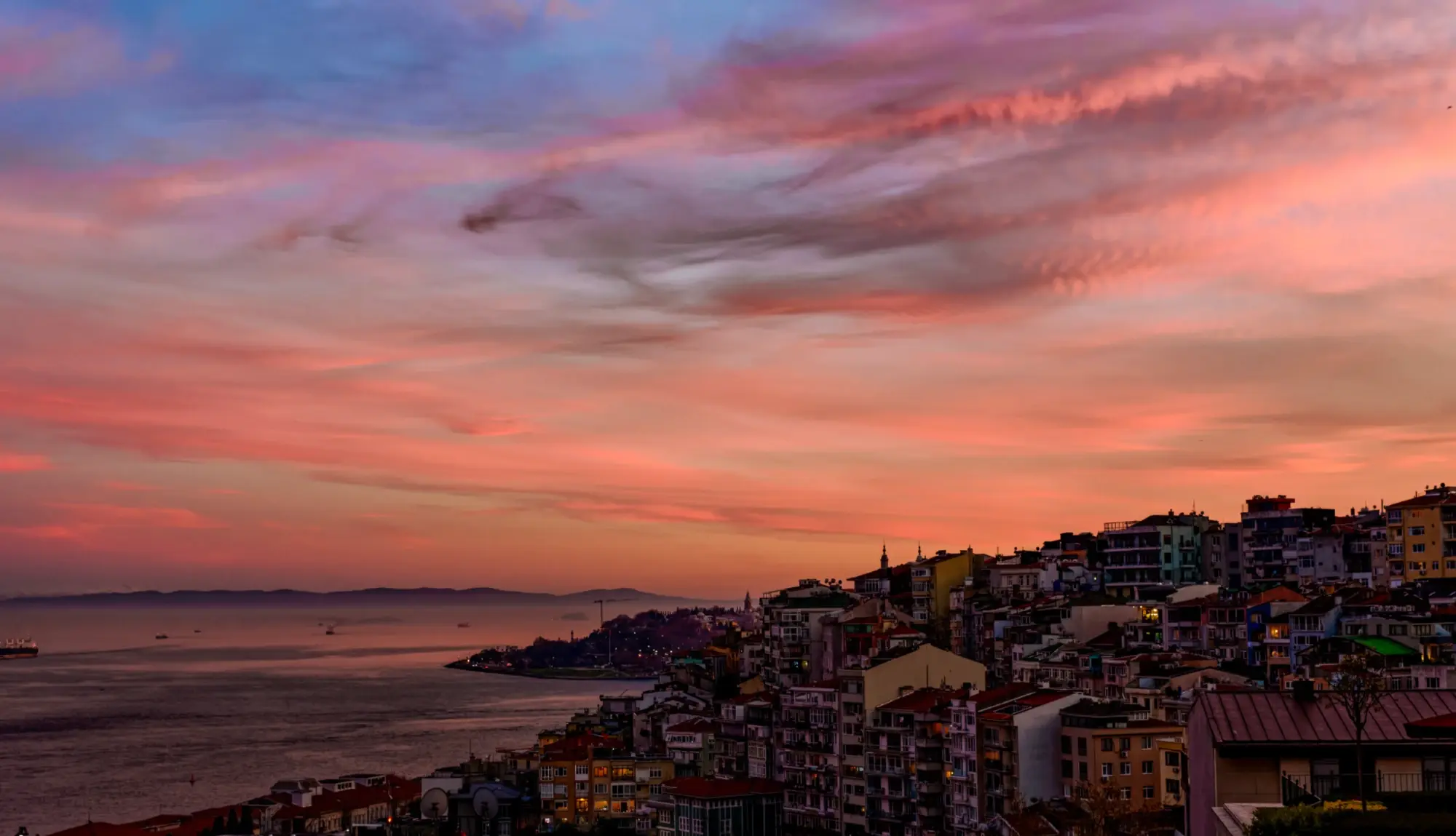 Cihangir's rooftops and the sea at sunset